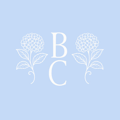 White floral designs with initials 'B' and 'C' on a light blue background